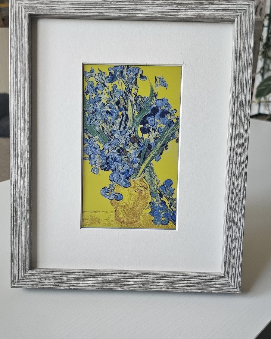 CanvasBT frame displaying blue irises, standing on a white sideboard
